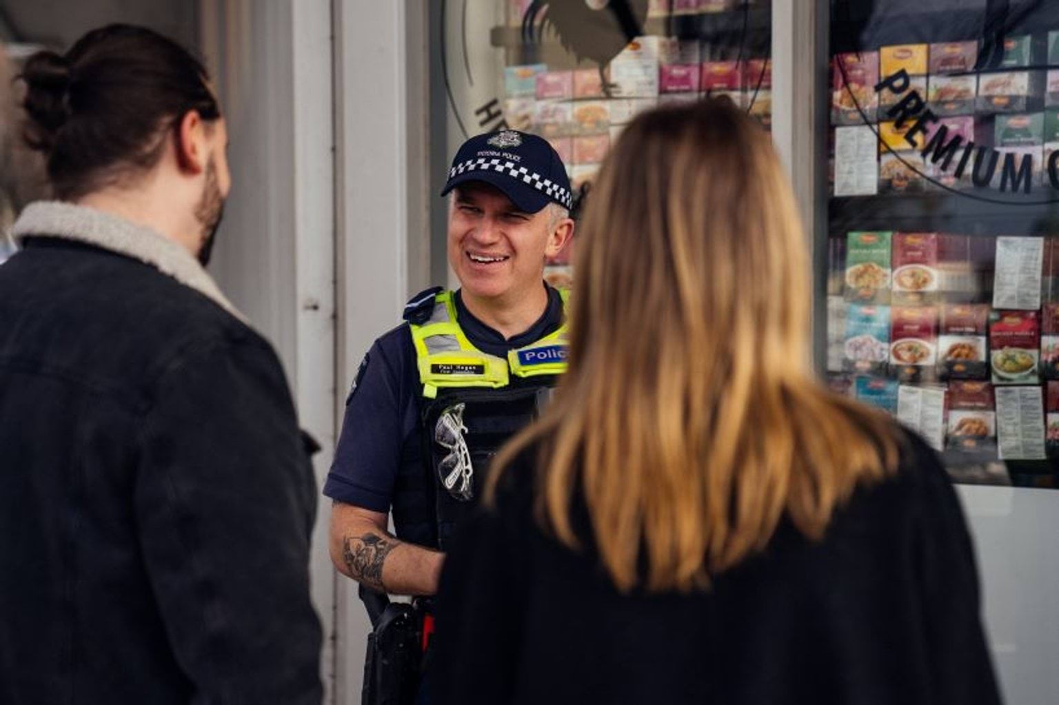 Police officer talking to members of the community.