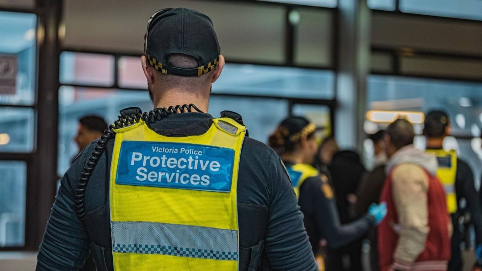 Protective services officers at the train station assisting the public.