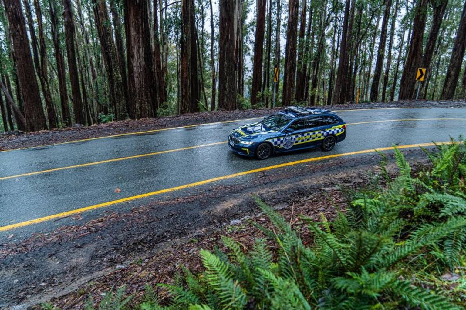 Police car driving on wet roads.