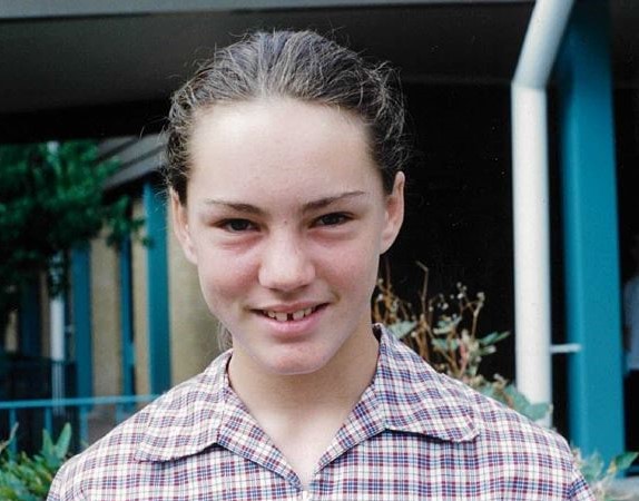 Missing person Cherie Westell, brown hair in a ponytail, wearing a red and white checked top. 