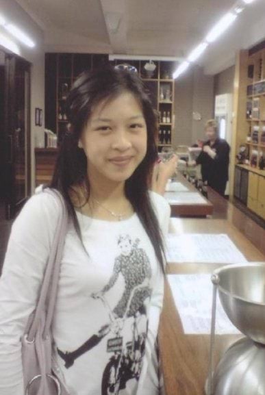 Sally Cheong, with long black hair, wearing a white long sleeves shirt. 