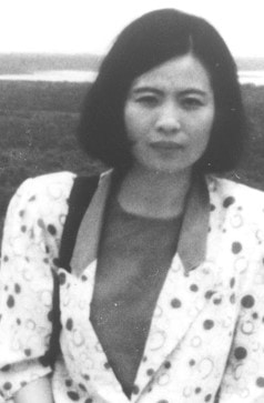 Yue Ling Zhang, with short black hair, wearing a blazer with circles.