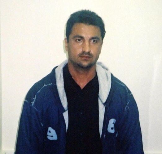 Mohammad Keshtiar, wearing a black shirt and blue hooded jacket.