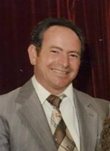 Salvatore Rotiroti wearing a grey suit, with short black hair
