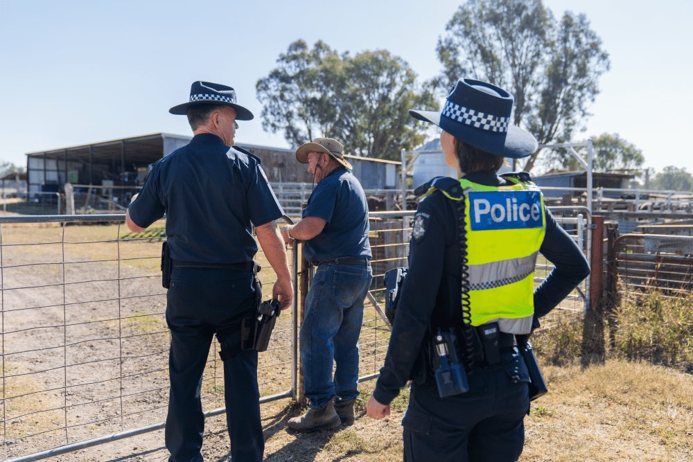 Two Farm Crime Liaison Officers walking with a farmer on his farm. 