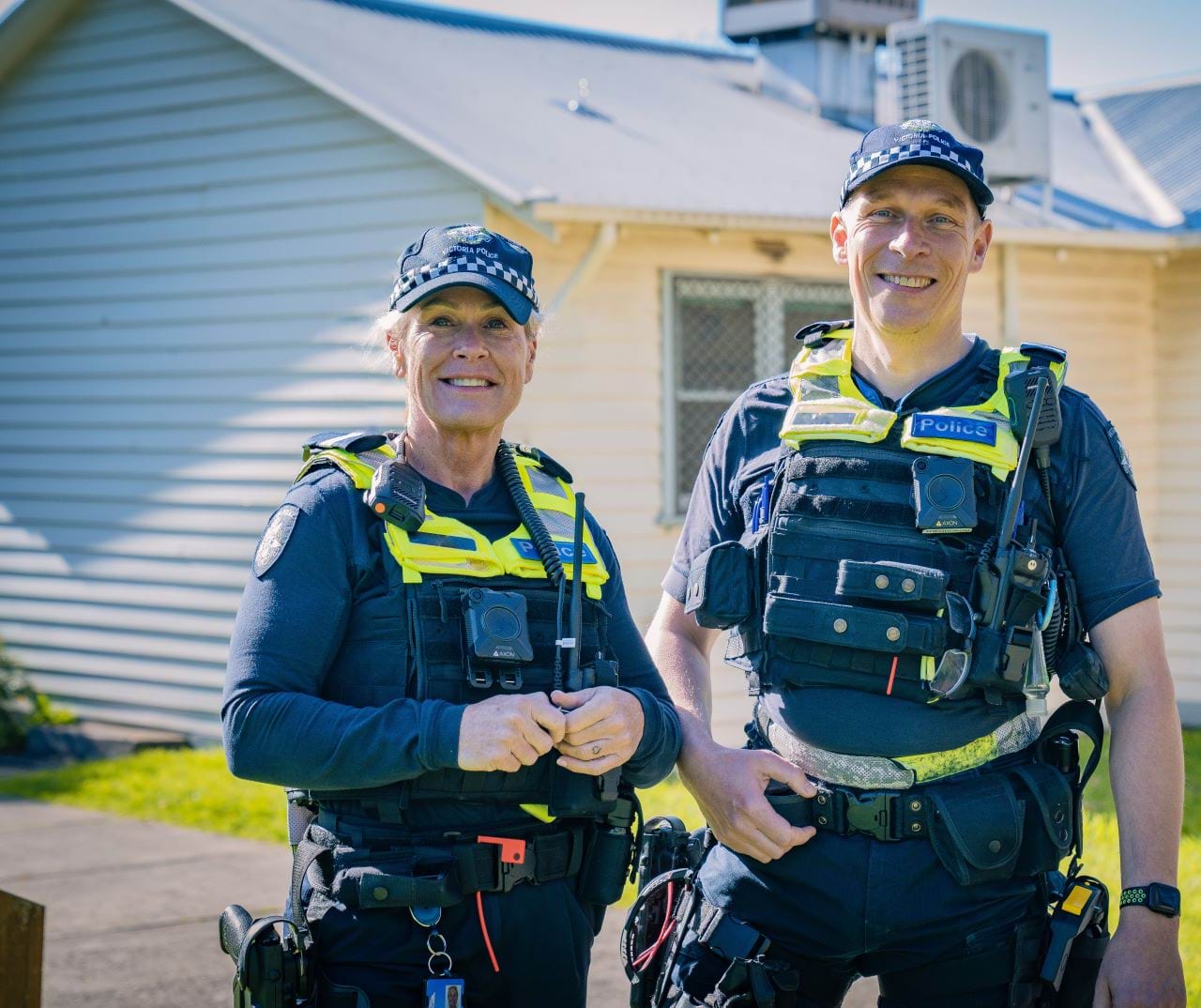 Two police officers in police uniform, one man and one woman. 