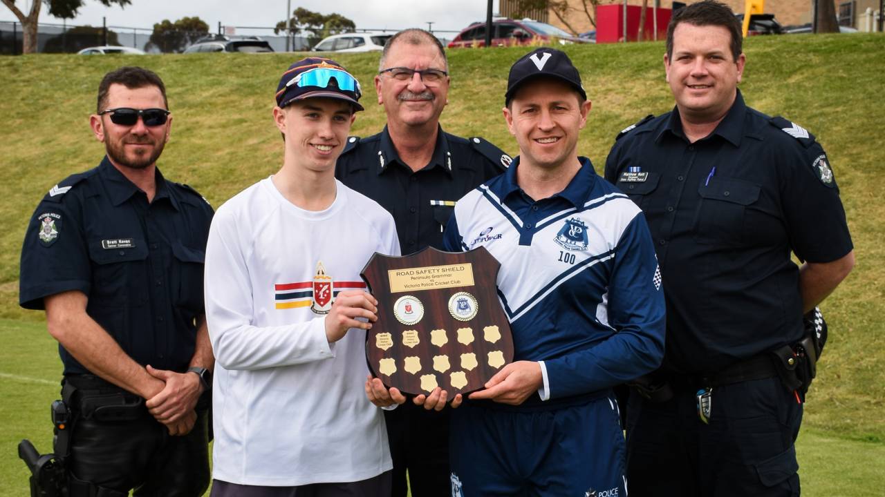 Police Life stories - Cricket a vehicle for road safety - officers and students on cricket pitch