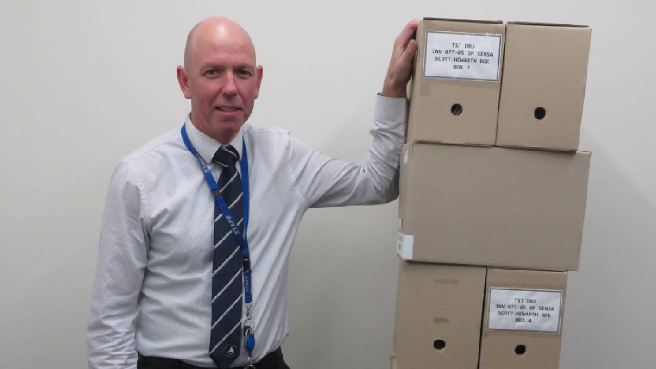 Police Life stories - Detective’s perseverance pays off - Det Sgt Sam Greenham with boxes