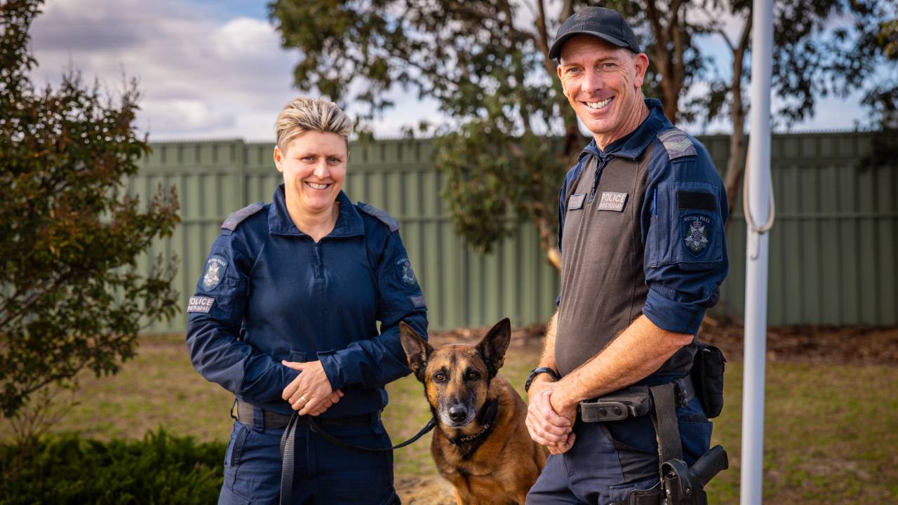 News - Police Life podcast - Two smiling officers with a police dog