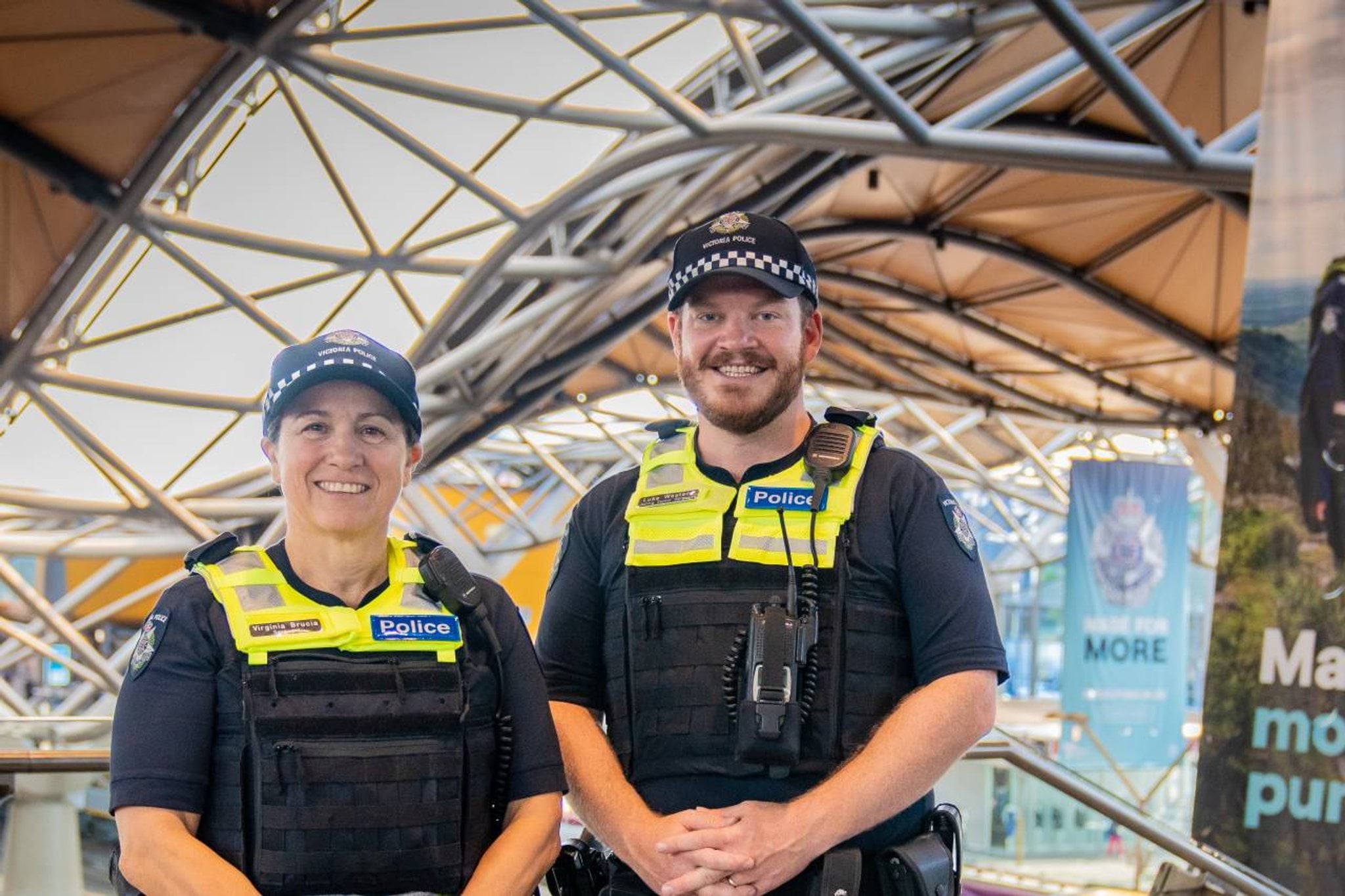 Homepage - Two smiling officers at a train station 