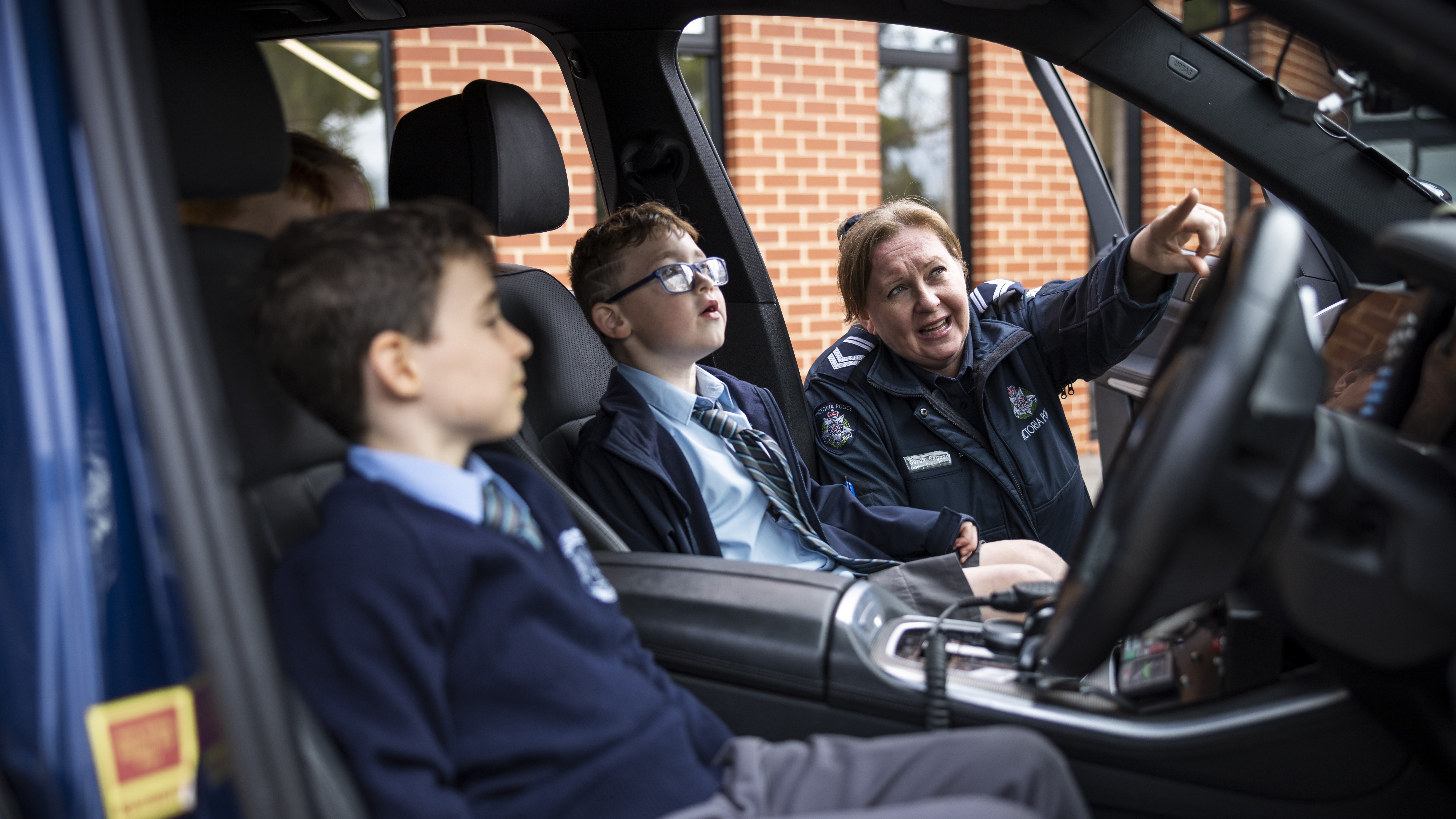 News - Police Life - Classroom connections - Ldg Sen Const Sarah Reggardo and school children in police car - 1280x720 - in-page