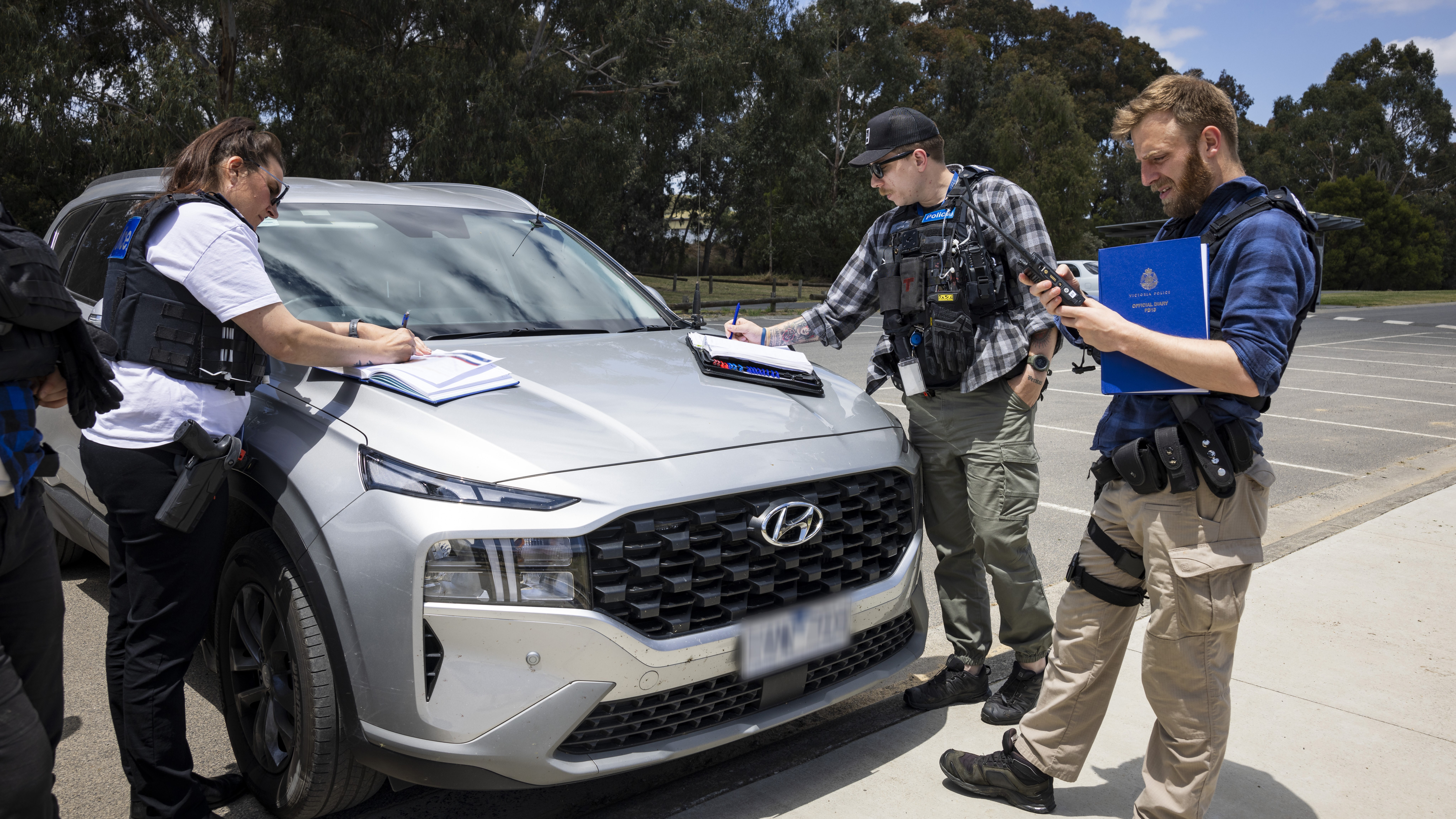 News - Police Life - Hot on the trail - FVC taskforce take notes outside car - 1280x720 - in-page