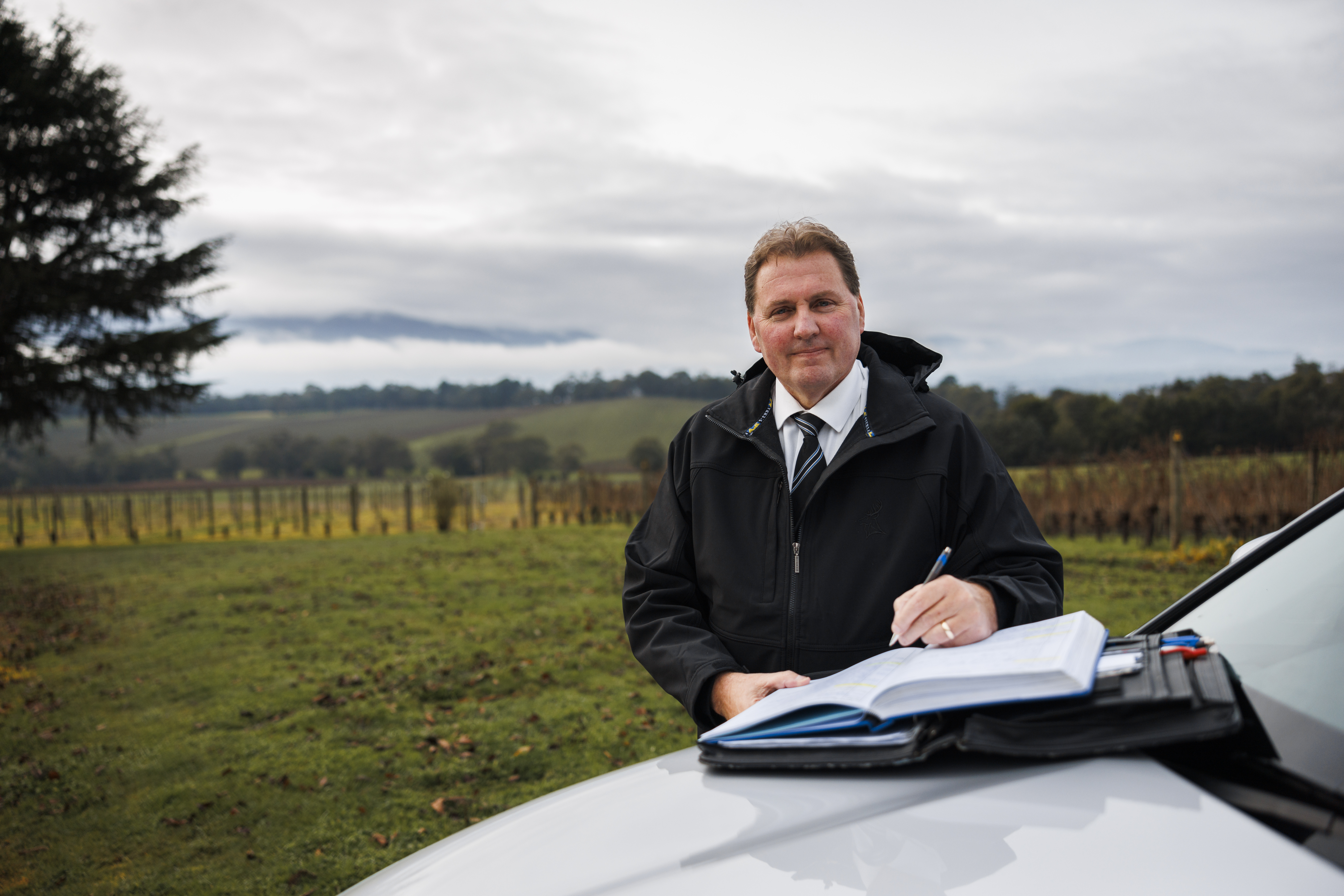 Police Life stories – Behind the Bade Stephen Sheahan - Police officer standing in open field 1280x720 – Feature