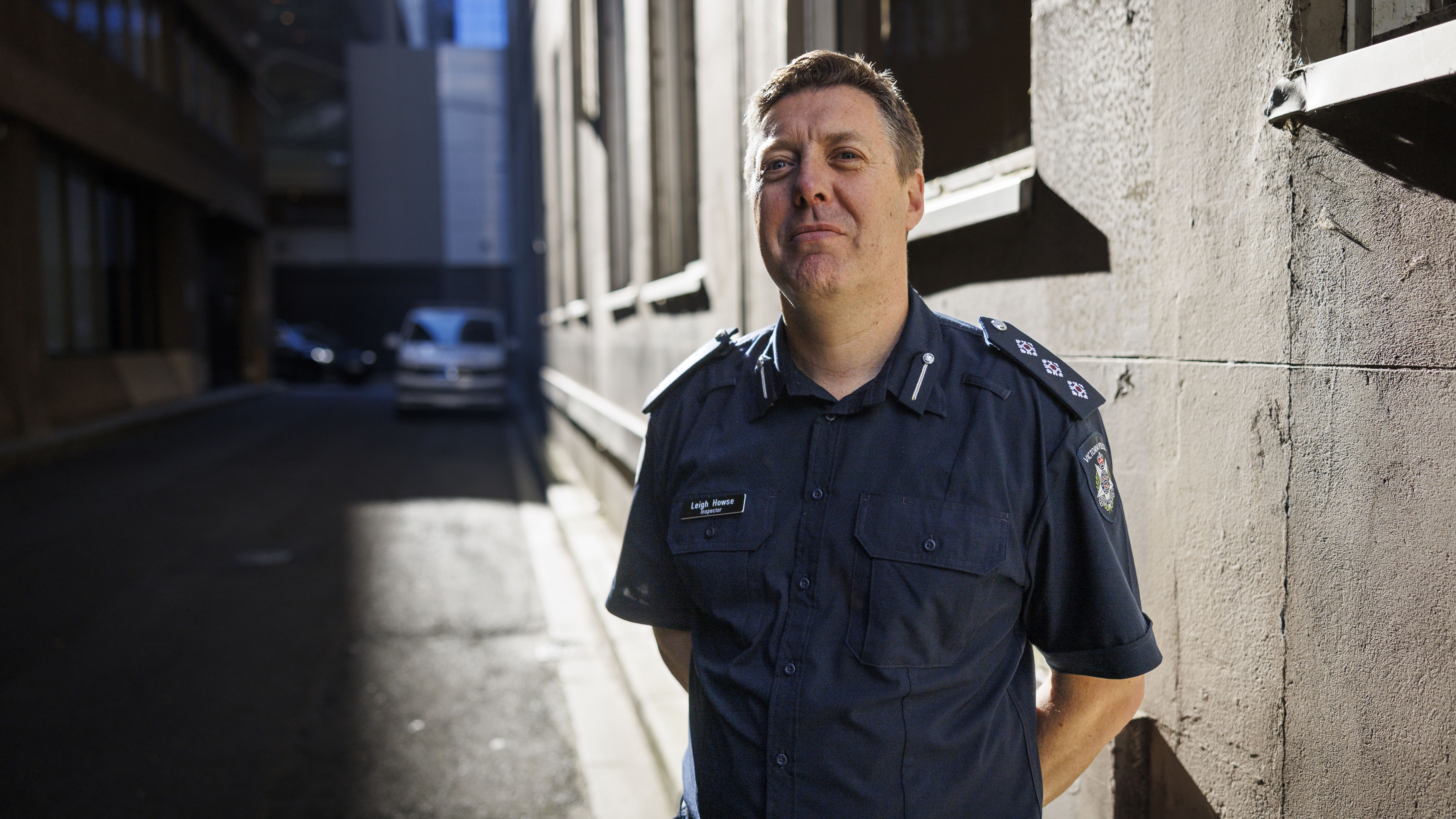 Police Life - police officer of inspector rank standing in a dark Melbourne laneway