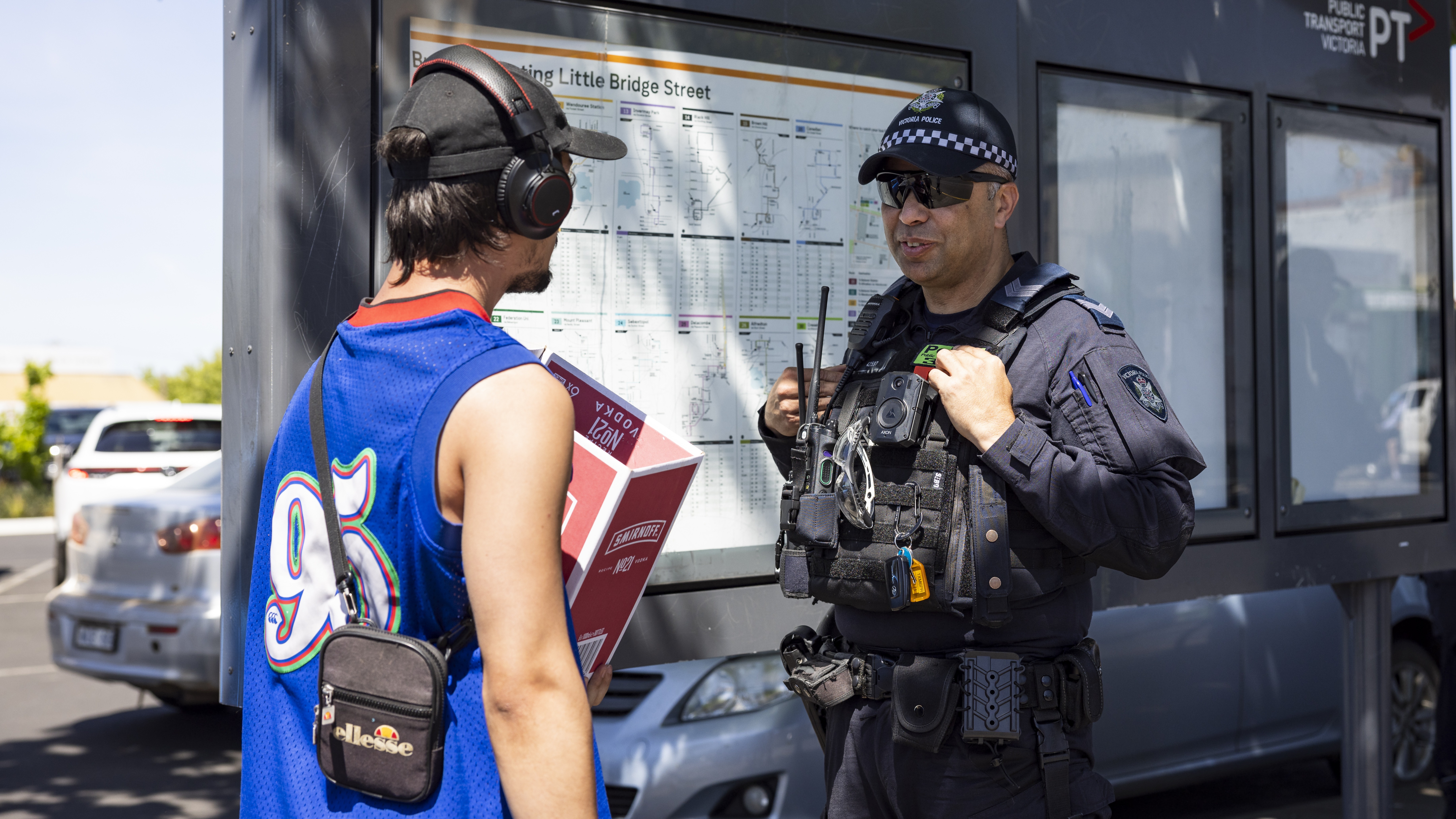 Police Life - A male Public Order Response Team officer speaking with a young male at a bus stop