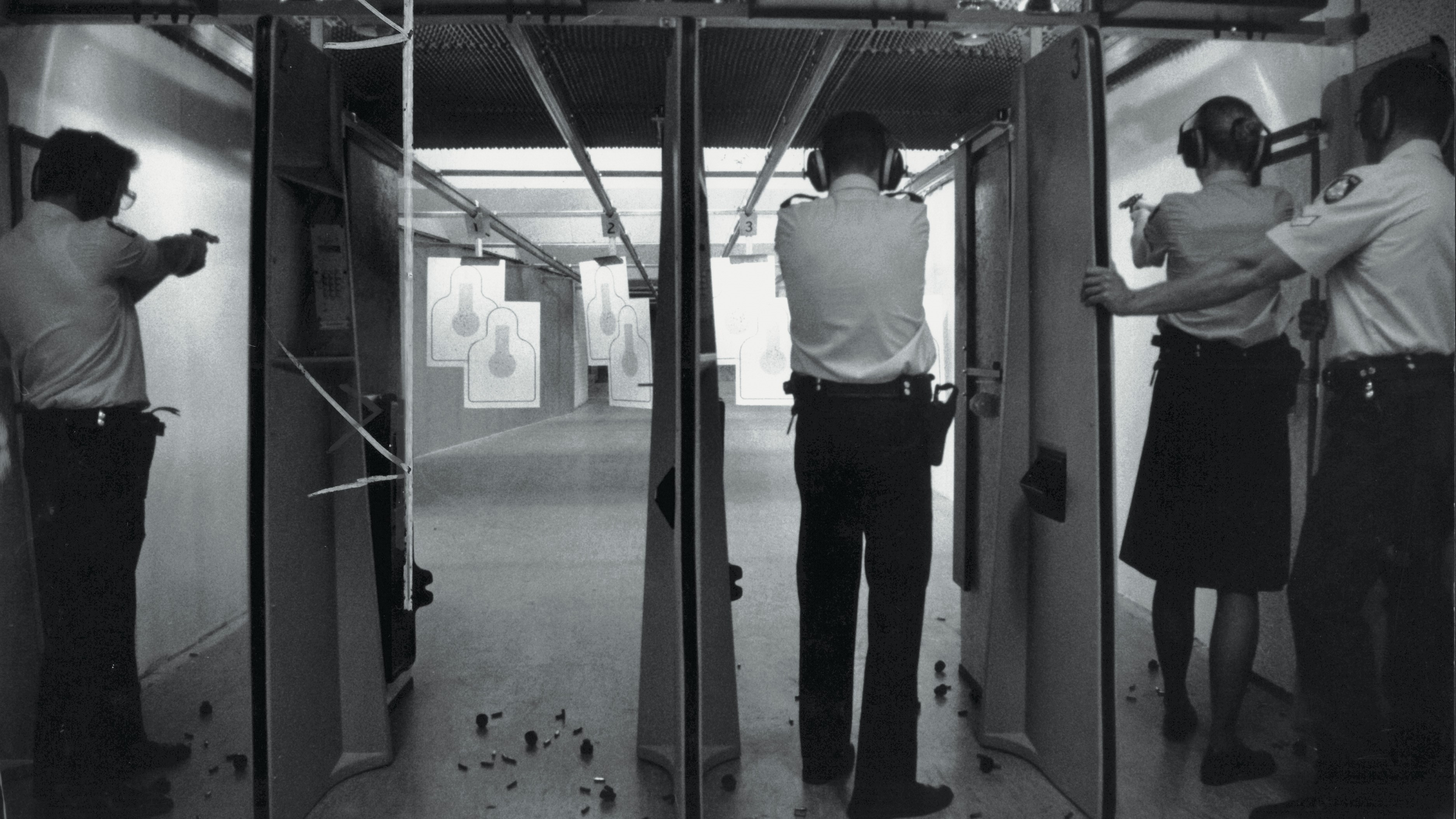 Police Life - black and white image of members using a shooting page in 1992.