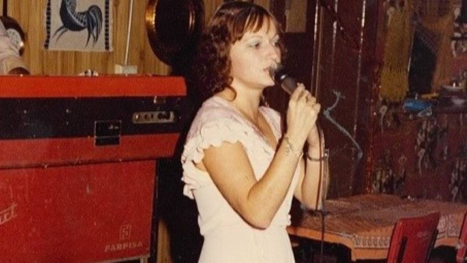 Haroula Kipouradou wearing a white dress