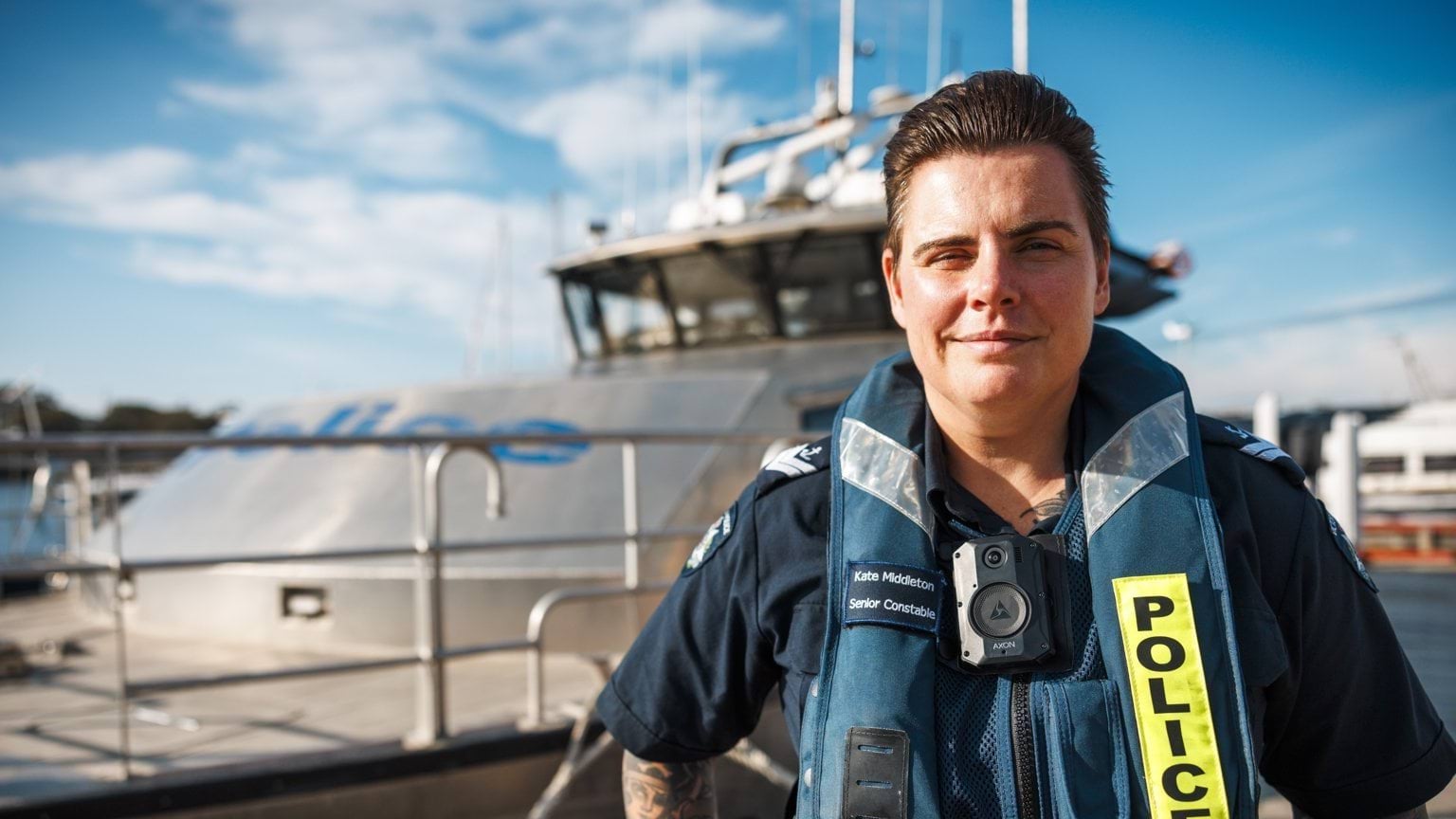 Senior Constable Kate Middleton with a Water Police boat in the background.
