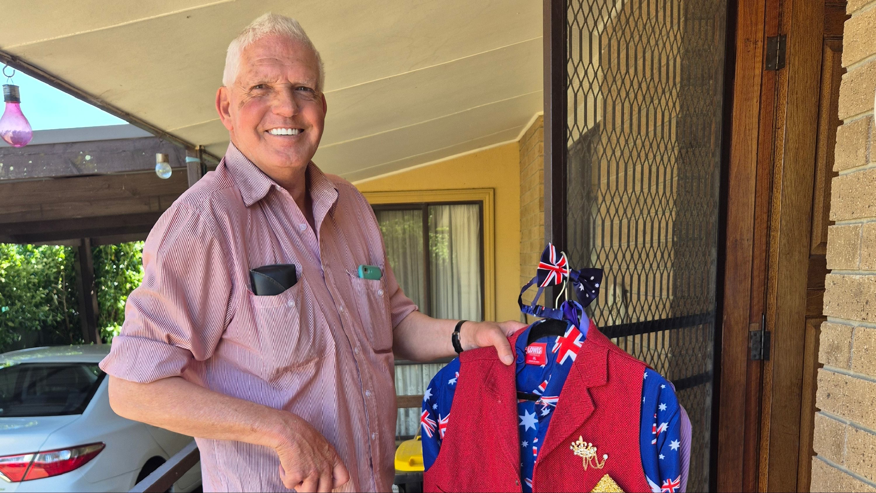 A Stawell local holding a colourful ballroom dancing outfit
