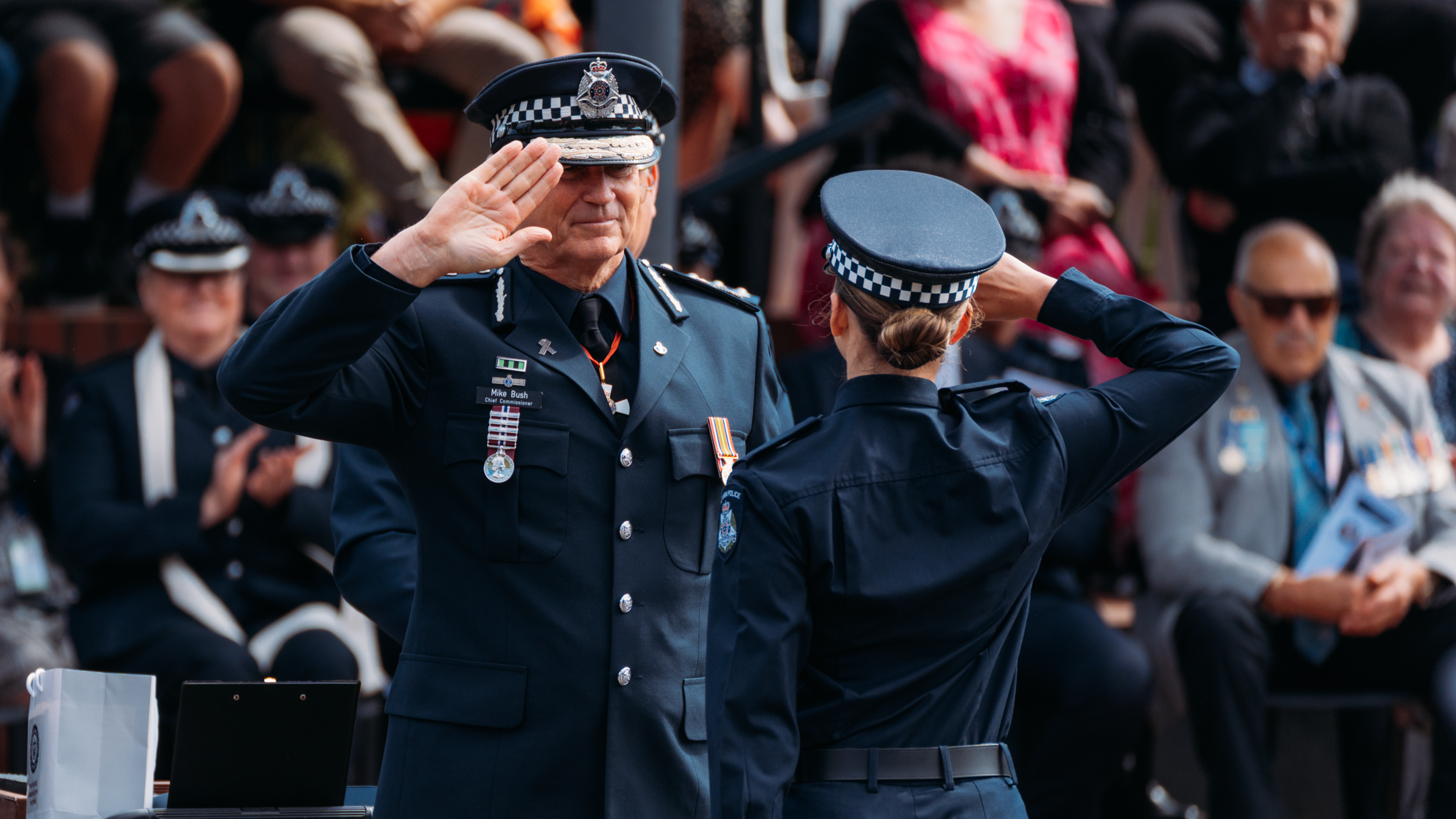 Chief Commissioner of Victoria Police Mike Bush salutes a new constable