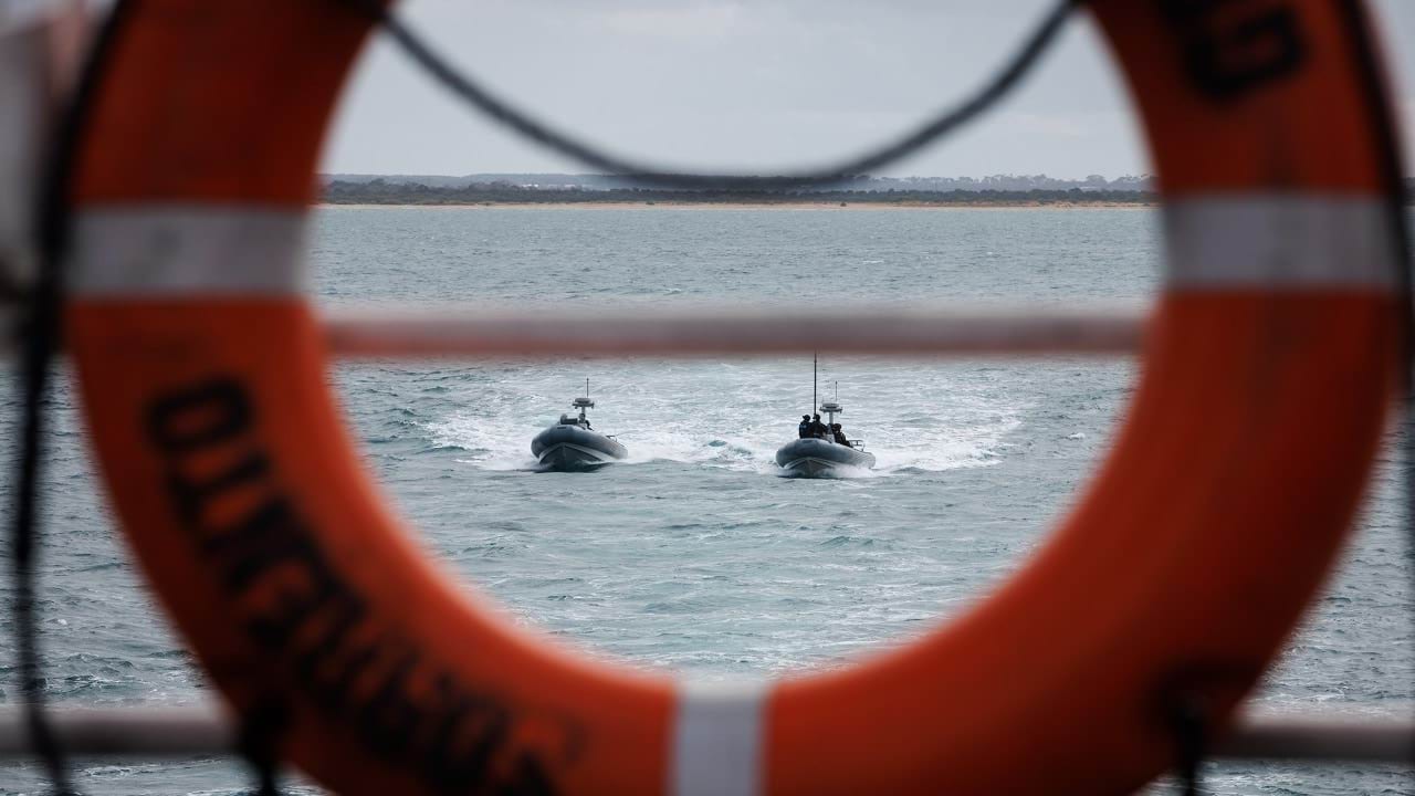 A view of two police boats coming towards the ferry