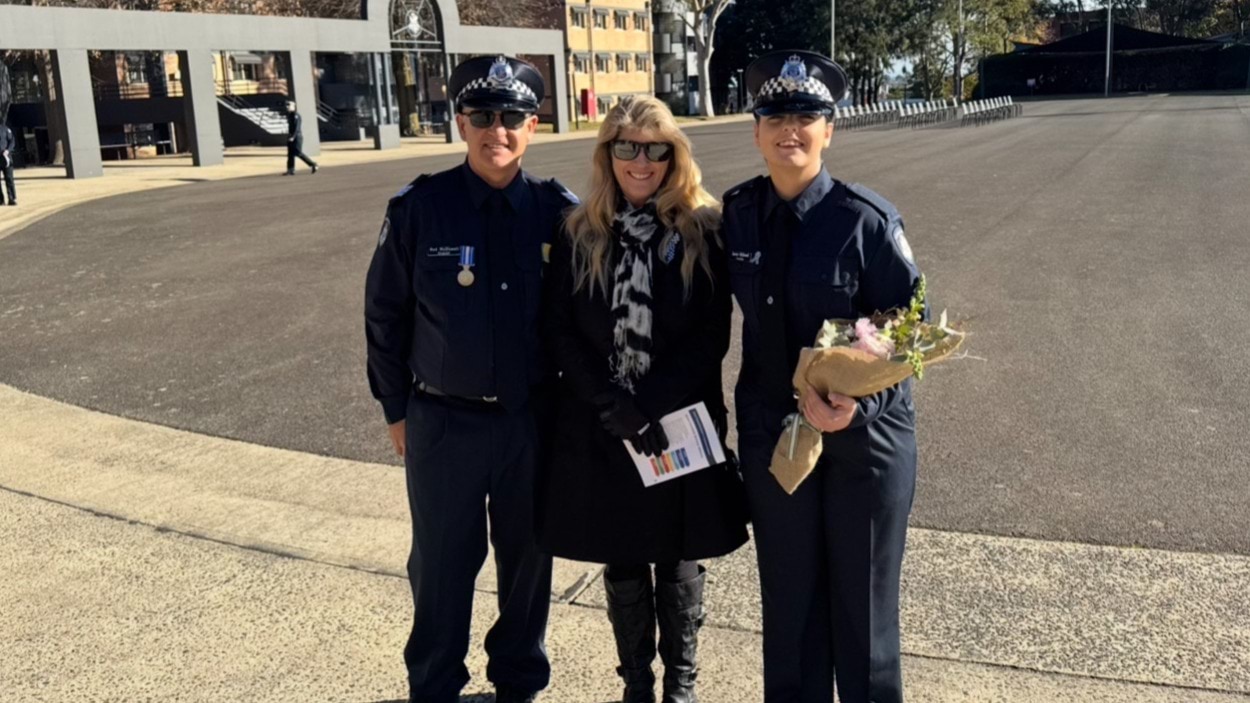 A male police officer, woman and young female police officer standing side by side at the Victoria Police Academy