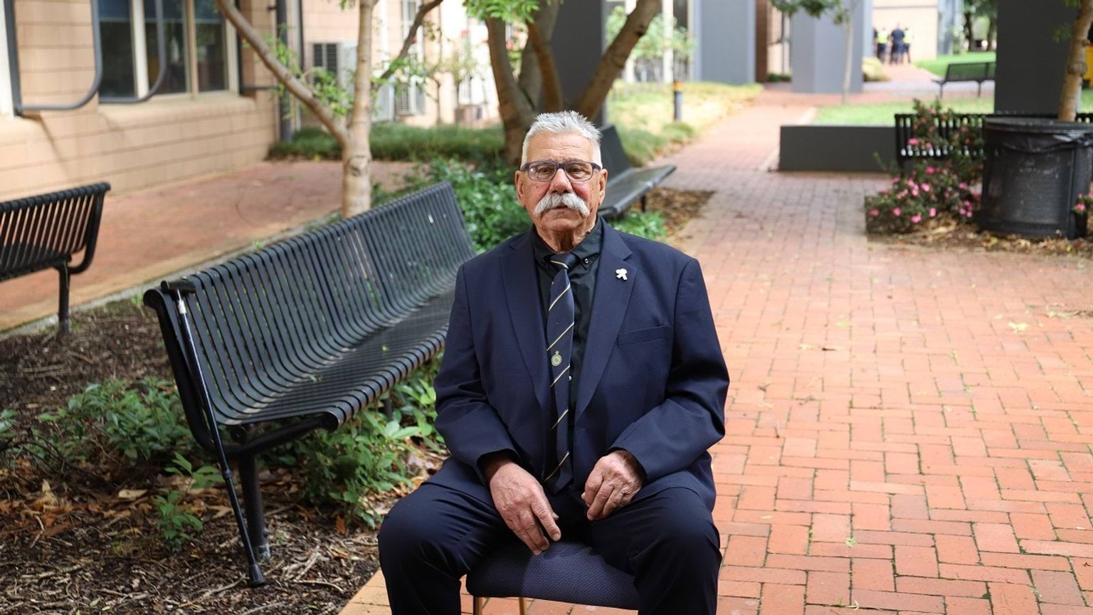 Police Life stories - George Halvagis sitting on chair