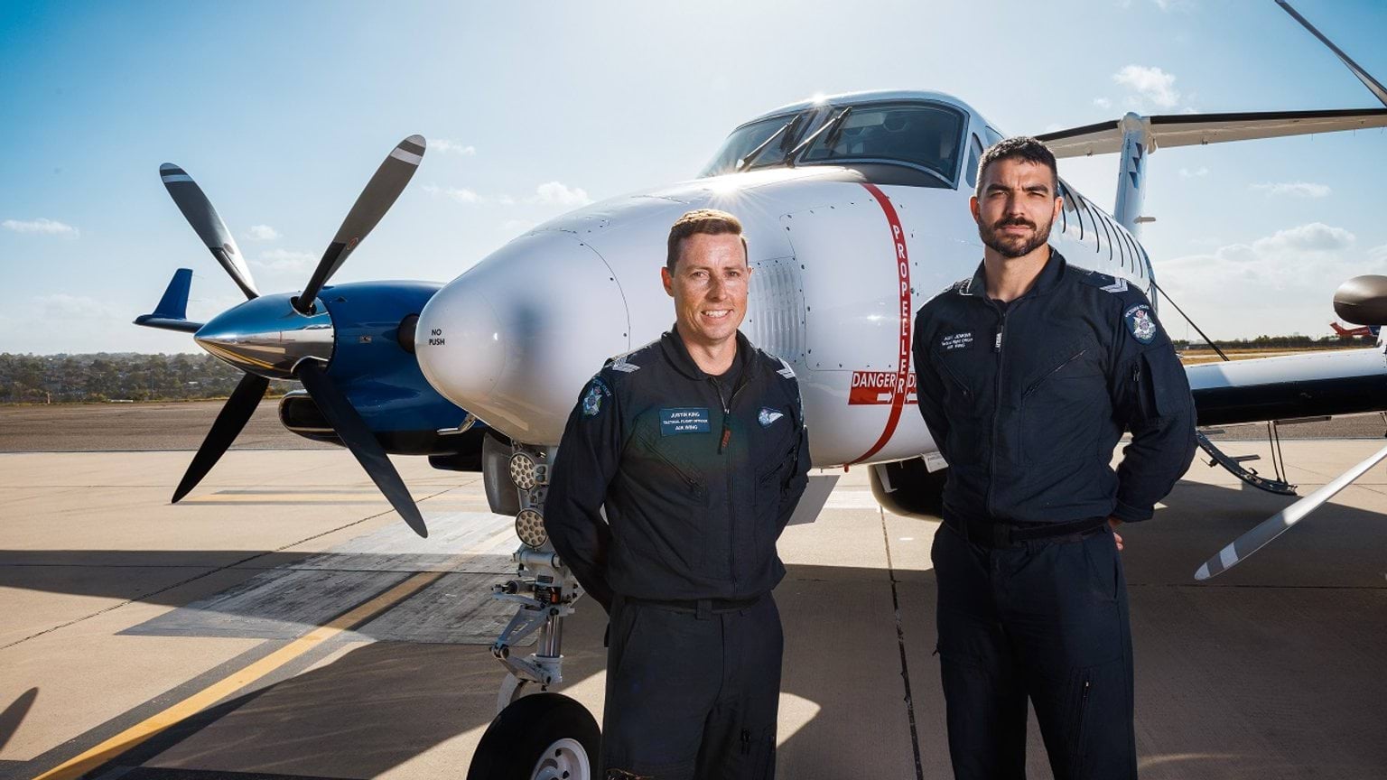 Police Life - Senior Constables Justin King and Alex Jenkins in front of Air Wing plane