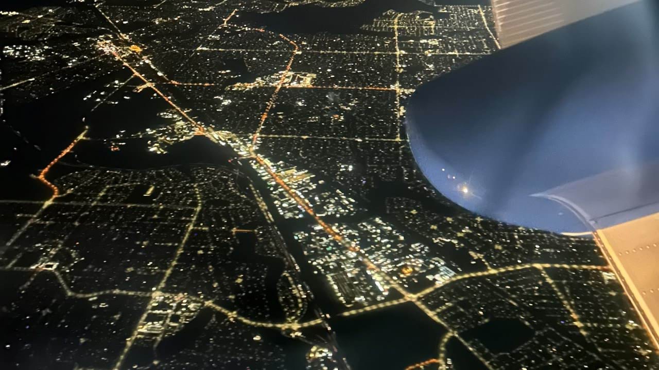 Night view of city streets from plane