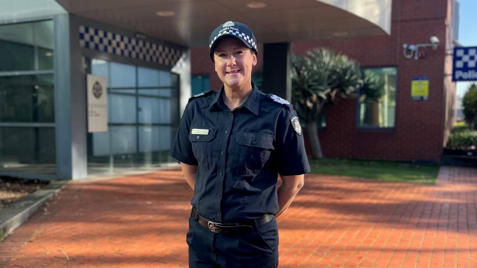 Female police officer standing in front of Geelong Police Station