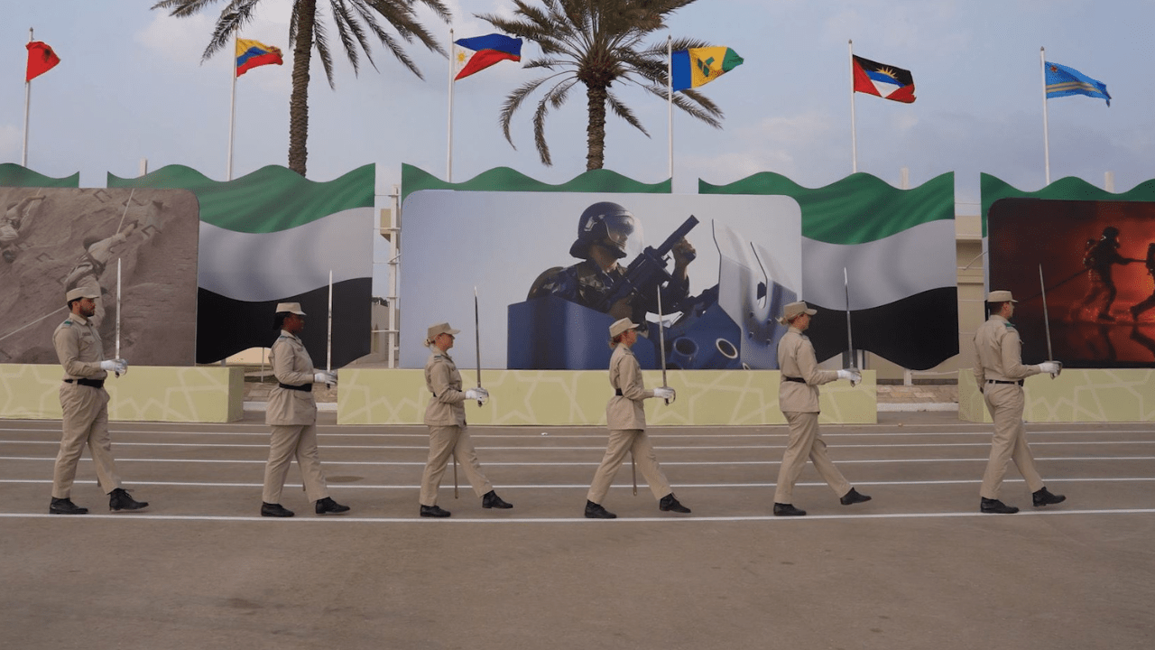Police Life: Det Ldg Sen Const Lewis marches in a line with four other recruits, all holding vertical swords, during training in the United Arab Emirates.