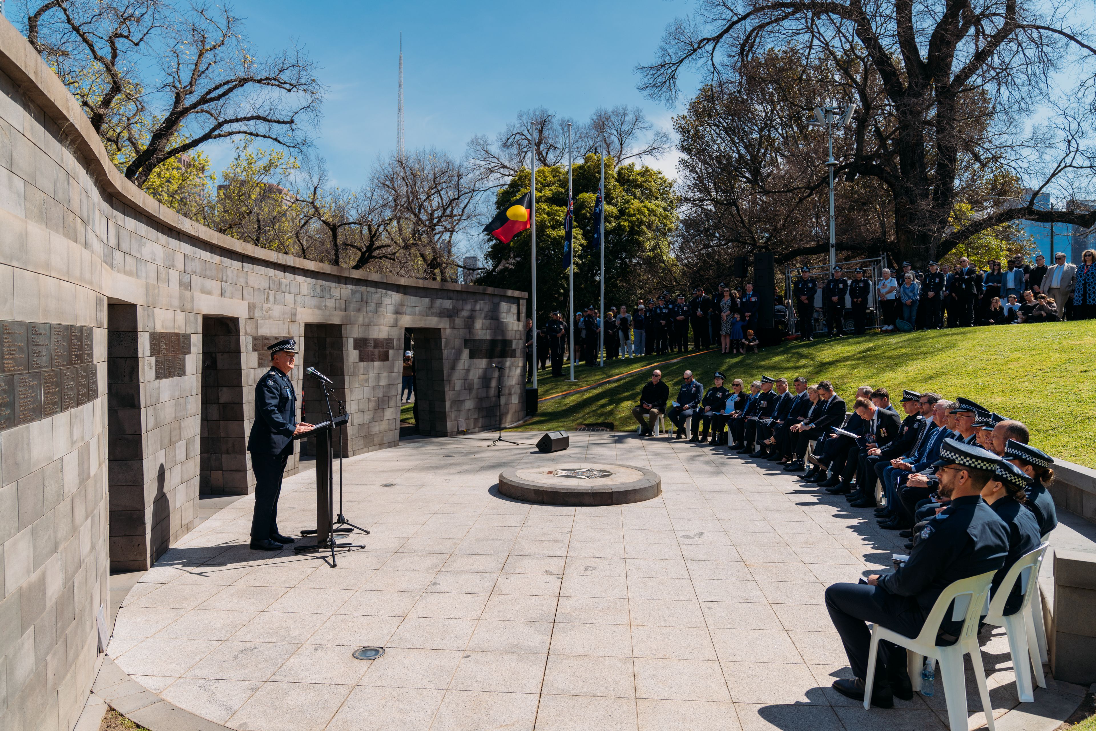 DC Hill standing at podium speaking to crowd at Victorian service.