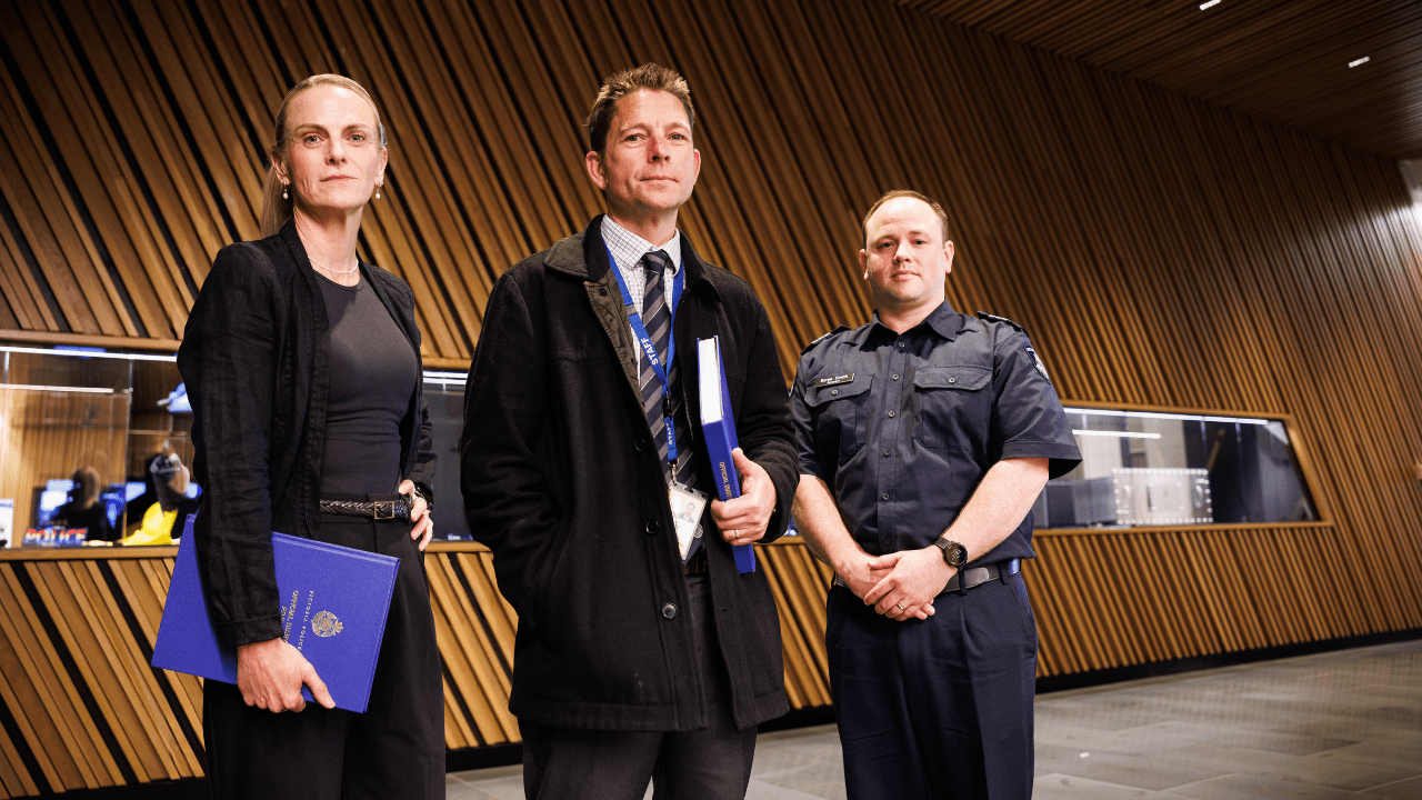 Det Ldg Sen Const Mervin is pictured standing alongside Victoria Police colleagues Det Sergeant Richard Thomson and Sgt Byron Smith, who worked together on a sexstortion case.