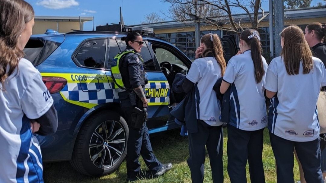 Police member speaking to students